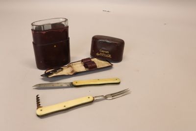 a knife, knife sharper, and a glass on a table