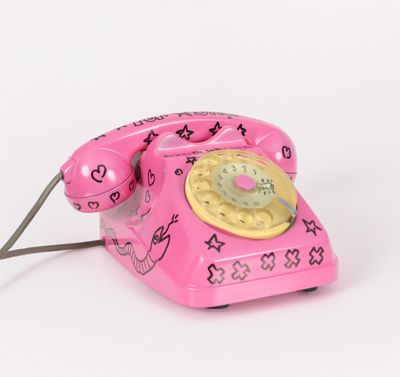 a pink telephone that has a heart design on it