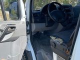 a white van with the door open and the driver ' s seat down