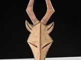 a wooden sculpture of a deer ' s head on a table