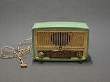 a green and yellow radio sitting on a gray surface