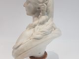 marble bust of a woman with braid hair on a marble base