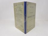 an old book with a blue cover sitting on top of a white table