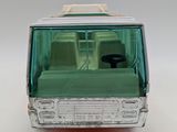 a toy bus that is sitting on a white surface