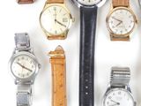 many different types of watches on a white surface