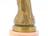 bronze statue of a woman holding a baby on a marble base