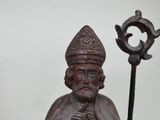 a statue of a man with a hat and a cane