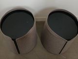 pair of round side tables with a black top and a grey base