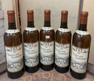 six bottles of wine are lined up on a table