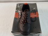 men ' s black leather shoes with orange laces on top of a box