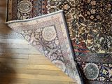 a large rug on the floor next to a chair
