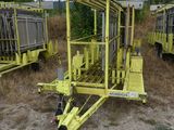 a yellow trailer that is parked in the dirt
