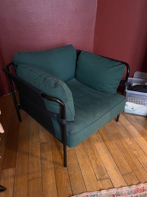 a green chair in the corner of a room