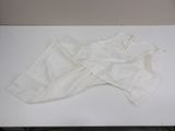 a piece of white cloth on a table with a pair of shoes