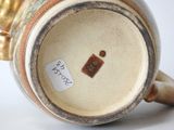 a close up of a vase with a tag on it