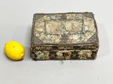 a small box with a lemon next to it on a table