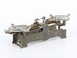 an old fashioned machine that is sitting on a white surface