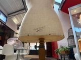 a mannequin sitting on a wooden stand in a room