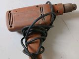 a drill with a cord attached to it sitting on a table