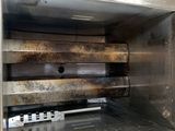 a metal oven that has a bunch of items inside of it