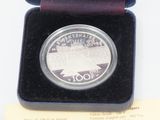 a silver coin that is in a box on a table