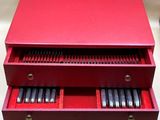 une image représentant une boîte rouge contenant un tas de stylos