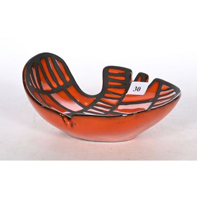 a red bowl with a black and white design on it
