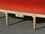 a bench with a red cushion on top of it