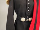 a black and red uniform with a gold buckle on the collar