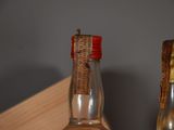 two bottles of alcohol sitting on a shelf