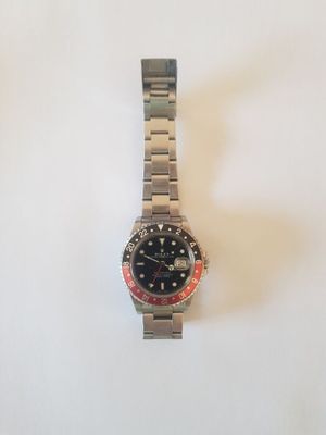 a close up of a watch on a white surface with a white background