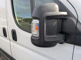 an image of a van with a parking meter in the side view mirror