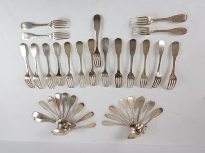 a lot of forks and spoons that are on the table