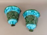 two blue and green vases sitting on a table