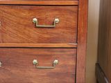 an image of a wooden dresser with marble top