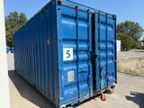a blue container sitting in the middle of a parking lot