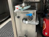 a machine that is sitting in a kitchen next to a fire hydrant