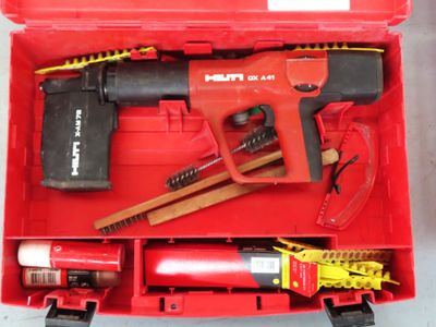 a red tool box with tools in it on a table