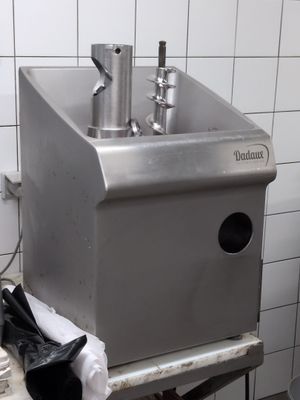 an image of a kitchen with a sink and a trash can