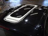 a black car with a white stripe on the roof