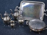 a silver tray with a silver tea pot and a silver tray with a silver tray and a silver tray with a silver tray and a silver tray with a