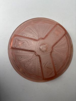 a pink plastic plate with a star wars design on it