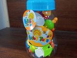 a plastic jar filled with lots of toys on a table
