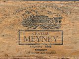 an old wooden box with a label on it sitting on a table