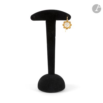 a close up of a pair of earrings on a stand
