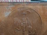 a brown purse with a picture of a man on a horse