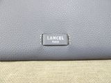 a close up of a bag with a tag on it