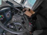 a steering wheel of a truck with a box on the back of it