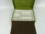a green case that has a lot of toothbrushes in it