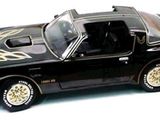 a black toy car with flames painted on the side of it
